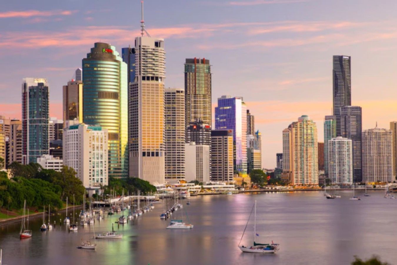 A city skyline with high-rise buildings and a marina with boats.
