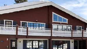 A two-story building with a red exterior, white railings, and large windows. - 7 Person Holiday Home in Salen (Transtrand)