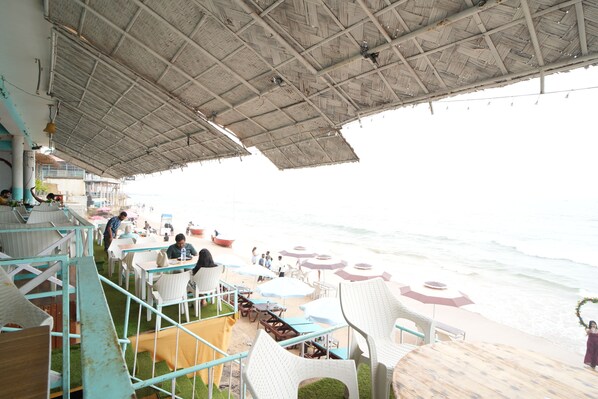 On the beach, white sand, sun loungers, beach umbrellas
