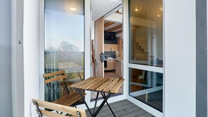 A modern kitchen with wooden cabinets and a visible staircase leading to an upper level. - Lovely apartment for 6 people with WIFI, A/C, TV and balcony (Ostrov)