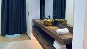 A modern bathroom with a wooden vanity, a large mirror, and a gold bowl. - Platinum Blue Island Resort (Akosombo)