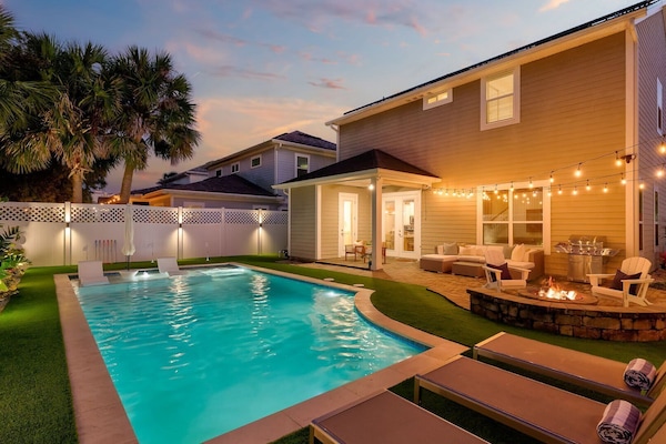 Cool off in the pool, challenge your friends to a round of putt-putt, and end the day with a fire – this backyard is pure bliss.