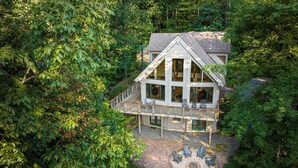 A two-story house with a deck, surrounded by dense trees. - Private Mountain Retreat near Breweries and Wineries (Lovingston)