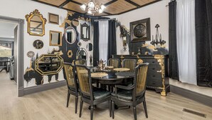 A dining area with a round table, chairs, and a chandelier. - Beautiful 3 bedroom uniquely designed home for small to large families! Pets ok! (Davenport)