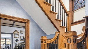 A wooden staircase with a stained glass window at the top. - Beautiful 3 bedroom uniquely designed home for small to large families! Pets ok! (Davenport)