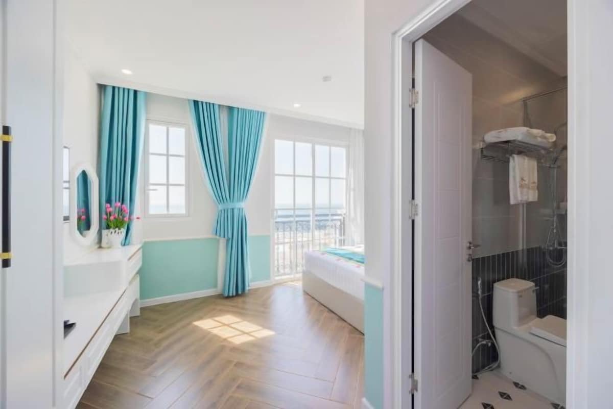 A bathroom with a shower, toilet, and sink.