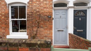 A brick house with a white window and a grey door. - Colourful, homely 2 bed terrace - Pass the Keys (Shrewsbury)