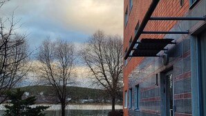A building with a brick facade and a window with a metal frame. - Lakeside Serenity in Lutakko | sauna, parking, A/C (Jyväskylä)