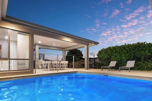 Enjoy a refreshing swim or relax in the private heated pool, nestled among lush greenery.