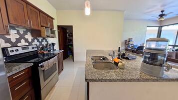 Coffee/tea maker, blender, cookware/dishes/utensils, kitchen islands