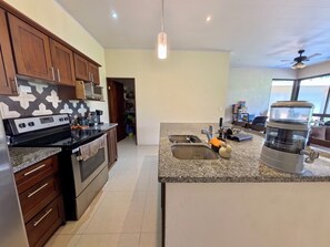 Coffee/tea maker, blender, cookware/dishes/utensils, kitchen islands