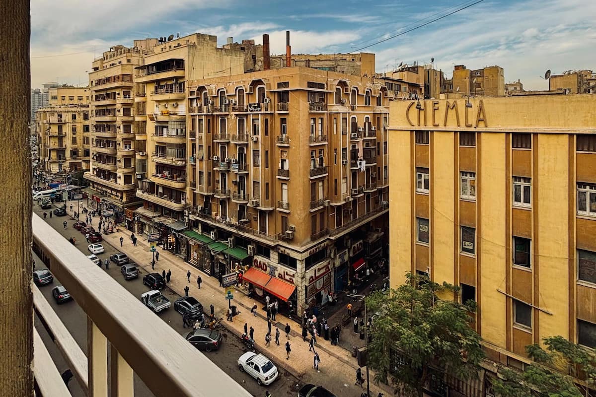 A multi-story building with balconies and a street view.