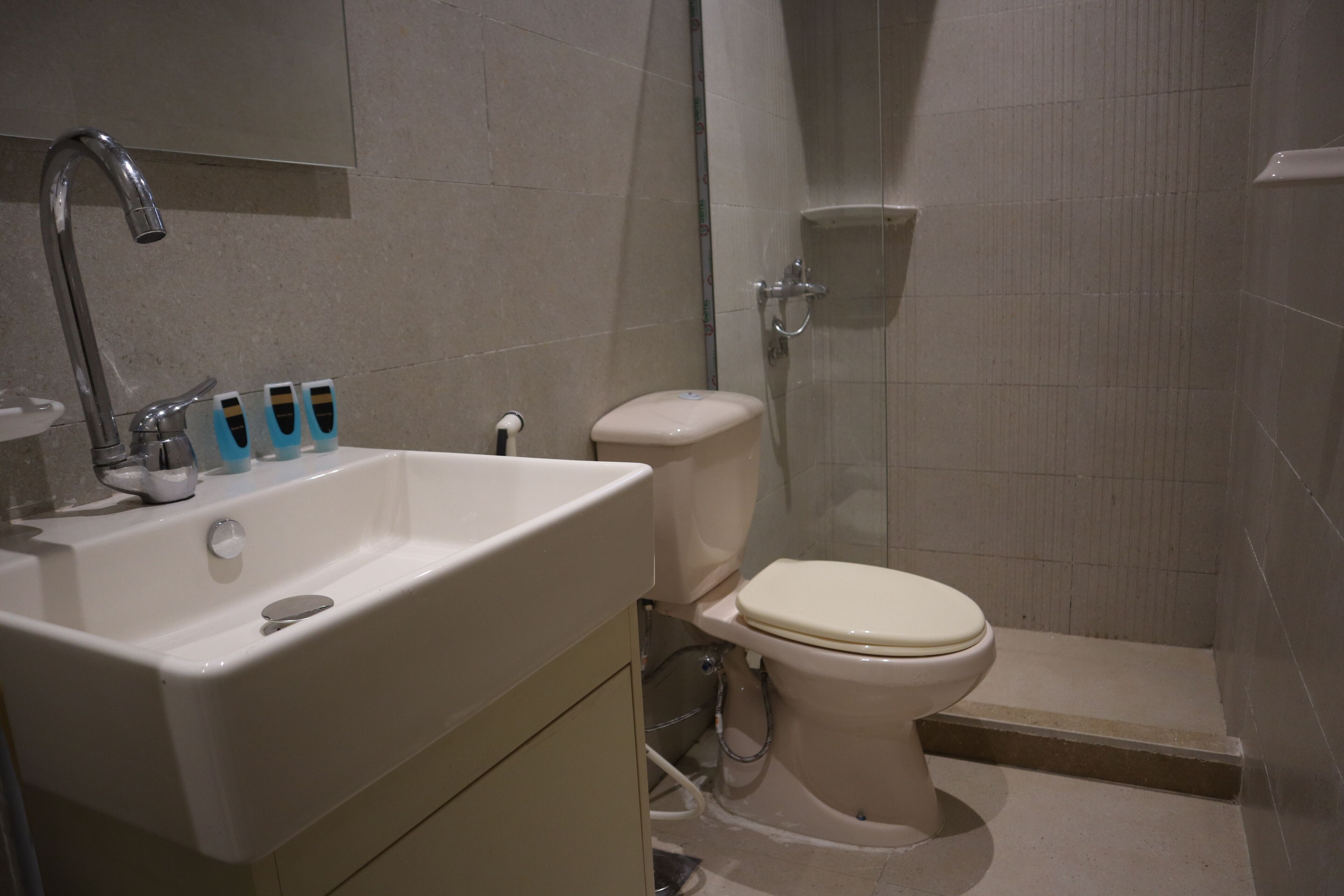 A bathroom with a sink, toilet, and shower.