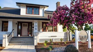 A two-story house with a white exterior, numbered 706, and a sign indicating it's a bed and breakfast. - The Compass McMinnville (McMinnville)
