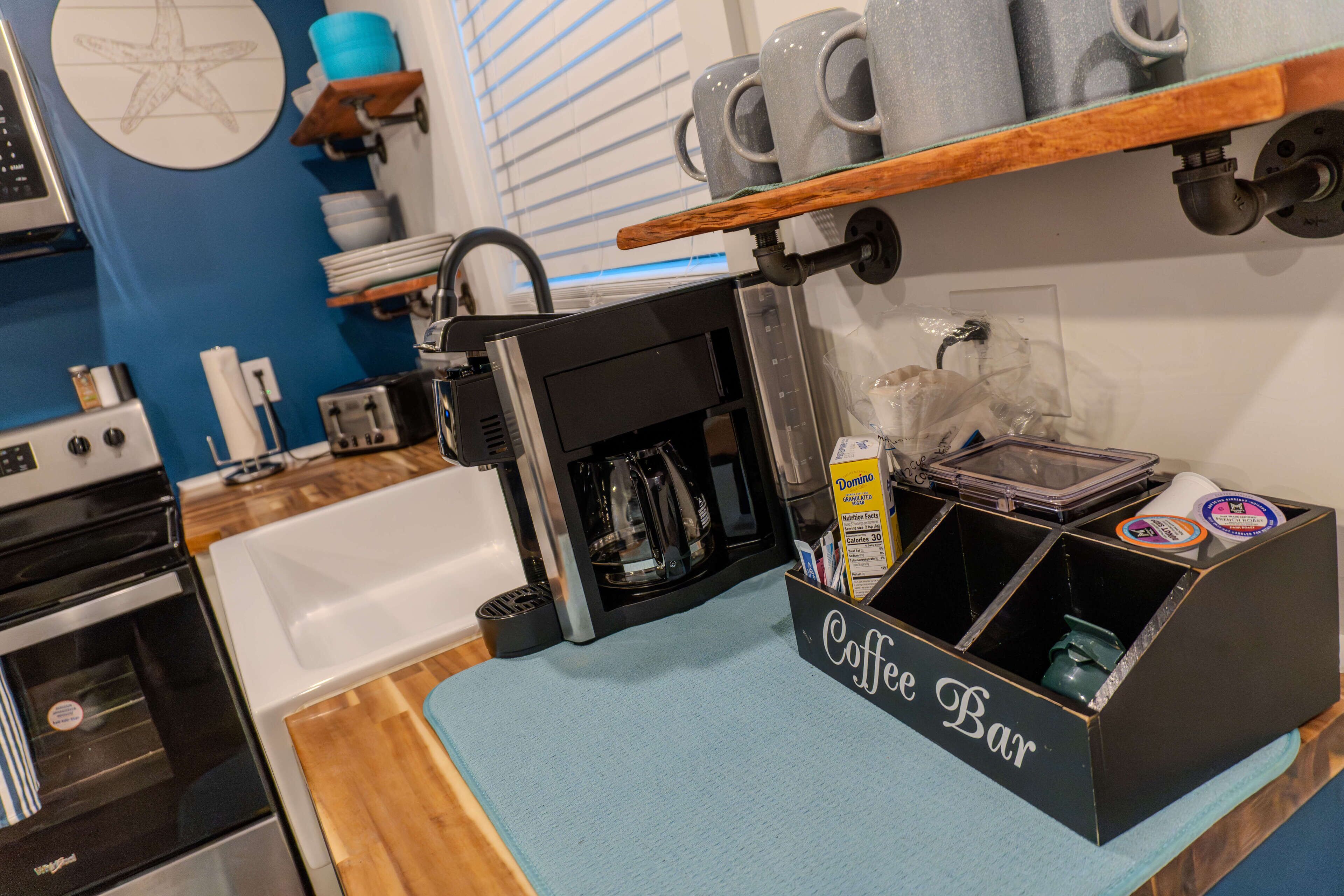 A kitchen with a coffee bar, a dishwasher, and a coffee machine.