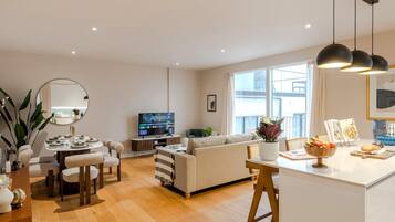 Superior Apartment, Balcony, City View | Living area | 50-inch Smart TV with digital channels