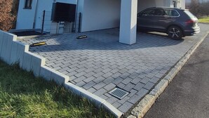 A modern two-story building with a flat roof, a garage, and a paved driveway. - Apartments Seibel double/twin room with balcony (Reutlingen)
