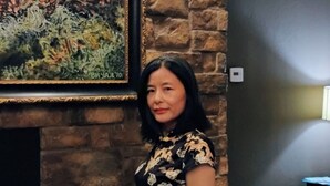 A person standing in a room with a stone wall and a framed artwork above a fireplace. - Lawton Creekside Villa,7 bedrooms, 3 bathrooms,8 beds,beautiful  neighborhood  (Lawton)