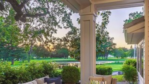 A covered outdoor seating area with a view of a golf course. - Silverado Napa Retreat, by Vinifera Homes (Napa)
