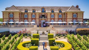 A large, historic building with a symmetrical facade, multiple windows, and a central entrance. - Silverado Napa Retreat, by Vinifera Homes (Napa)