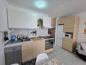 A modern kitchen with white cabinets, a built-in microwave, and a dishwasher. - Casa Samba, 2 Bedrooms and Pool (La Oliva)