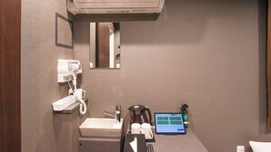 A hotel bathroom with a sink, mirror, hairdryer, coffee maker, and a laptop on the counter. - Epoch inn Nakasu (Fukuoka)