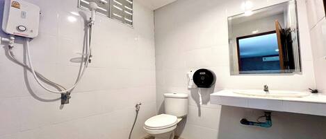 Ein Badezimmer mit Toilette, Waschbecken und Dusche.