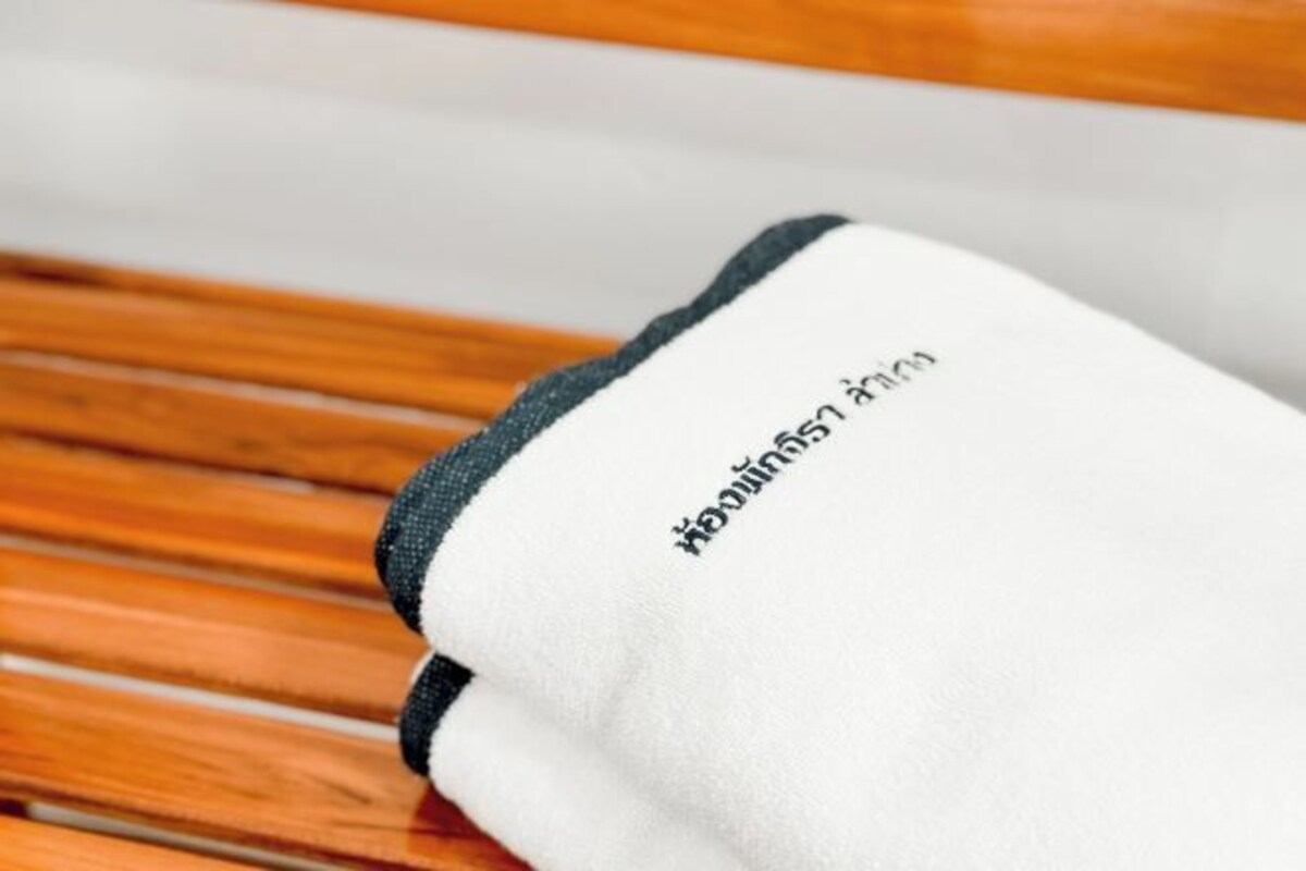 A white towel with black text on a wooden surface.