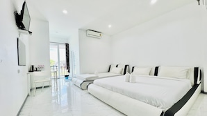 A modern hotel room with a large bed, a desk, and a chair. - Parichat Bandung Hotel (Ban Dung)