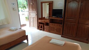 A hotel room with two beds, a TV, wooden furniture, and a tiled floor. - Phumchan Place Hotel (Phayao)