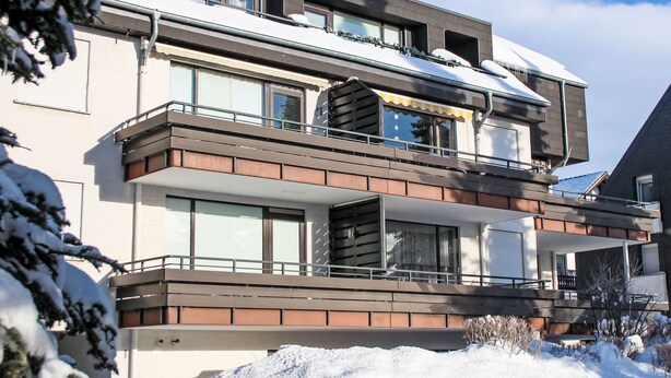 A multi-story residential building with balconies, large windows, and a snow-covered roof. - Fernblick by Interhome (Winterberg)