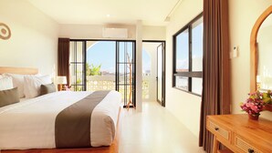 A hotel room with a large bed, a wooden dresser, and a balcony with a view. - The Canggu Dome 2-Roof Top Villa (Canggu)