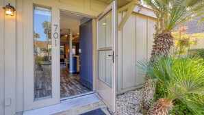A house entrance with a number 701, a door, and a small porch area with plants.