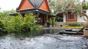 A traditional building with a steeply pitched roof and a water feature in front. - Eden Pool Villa  (Rawai)