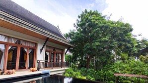 A house with a swimming pool, large trees, and a balcony. - Eden Pool Villa  (Rawai)