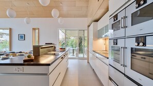A modern kitchen with white cabinetry, stainless steel appliances, and pendant lighting. - Jessamy - Wimborne, Dorset (Wimborne)