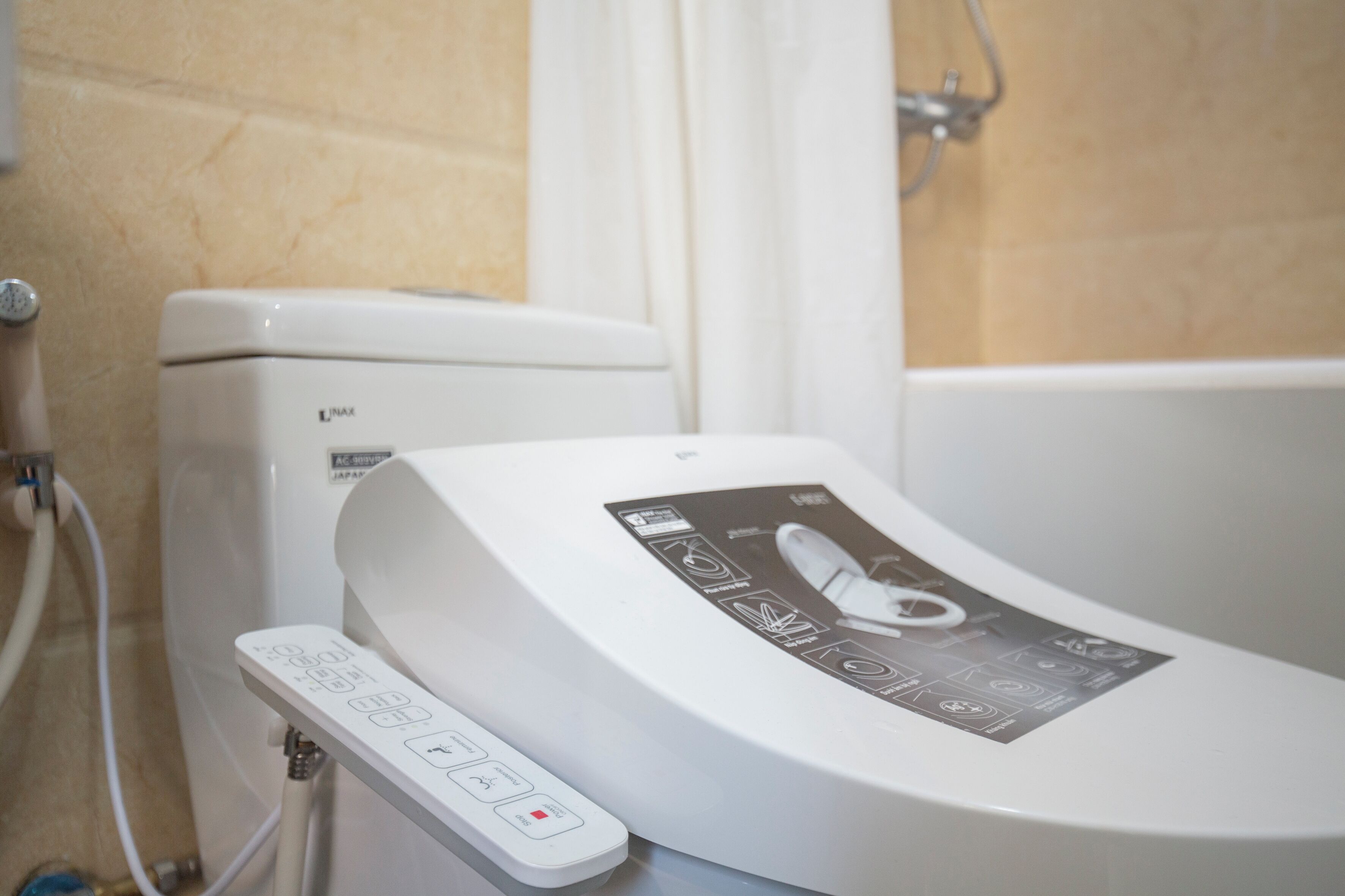 A modern bathroom with a toilet and a bidet.