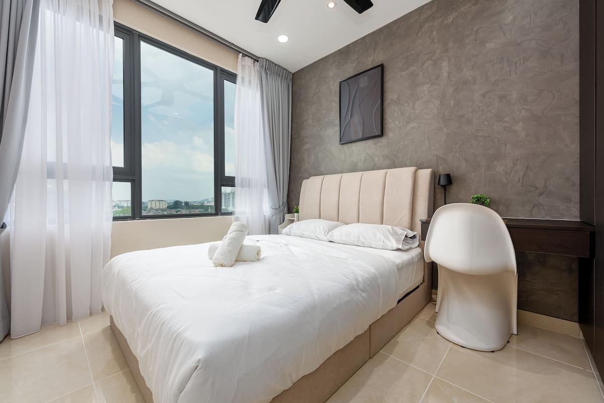 Una habitación de hotel moderna con una cama grande, vista del paisaje urbano a través de la ventana y un diseño minimalista.