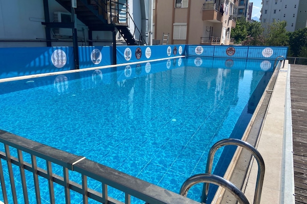 Seasonal outdoor pool, pool umbrellas, pool loungers