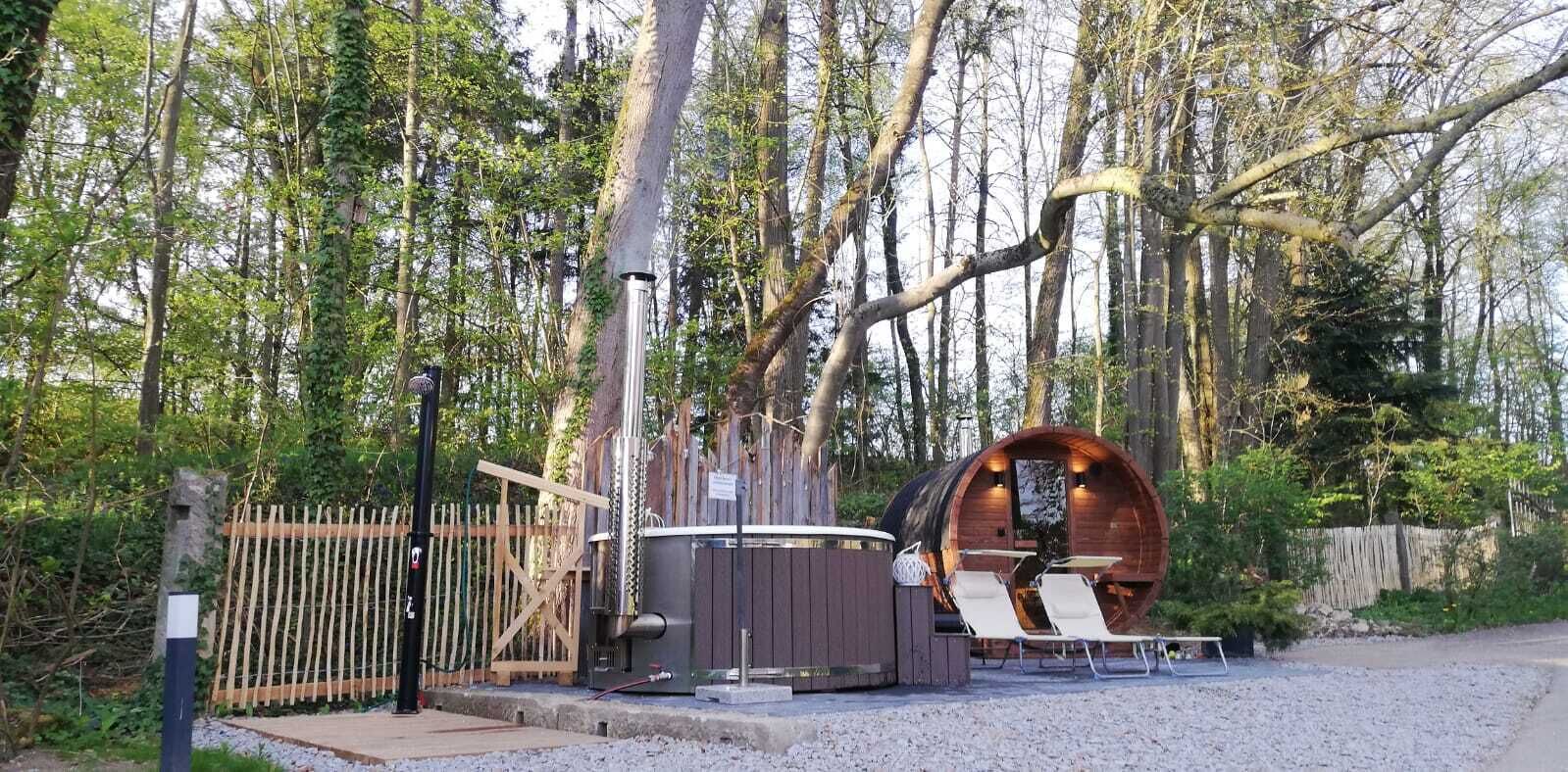 A rustic wooden cabin with a hot tub and outdoor seating.