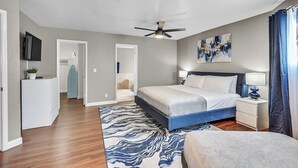 A bedroom with a bed, bedside tables, a ceiling fan, and a large window with curtains. - Grand Casa • 8bdr • Strip Views• 21 Beds • Free Spa Heat • Basketball • Events (Las Vegas)