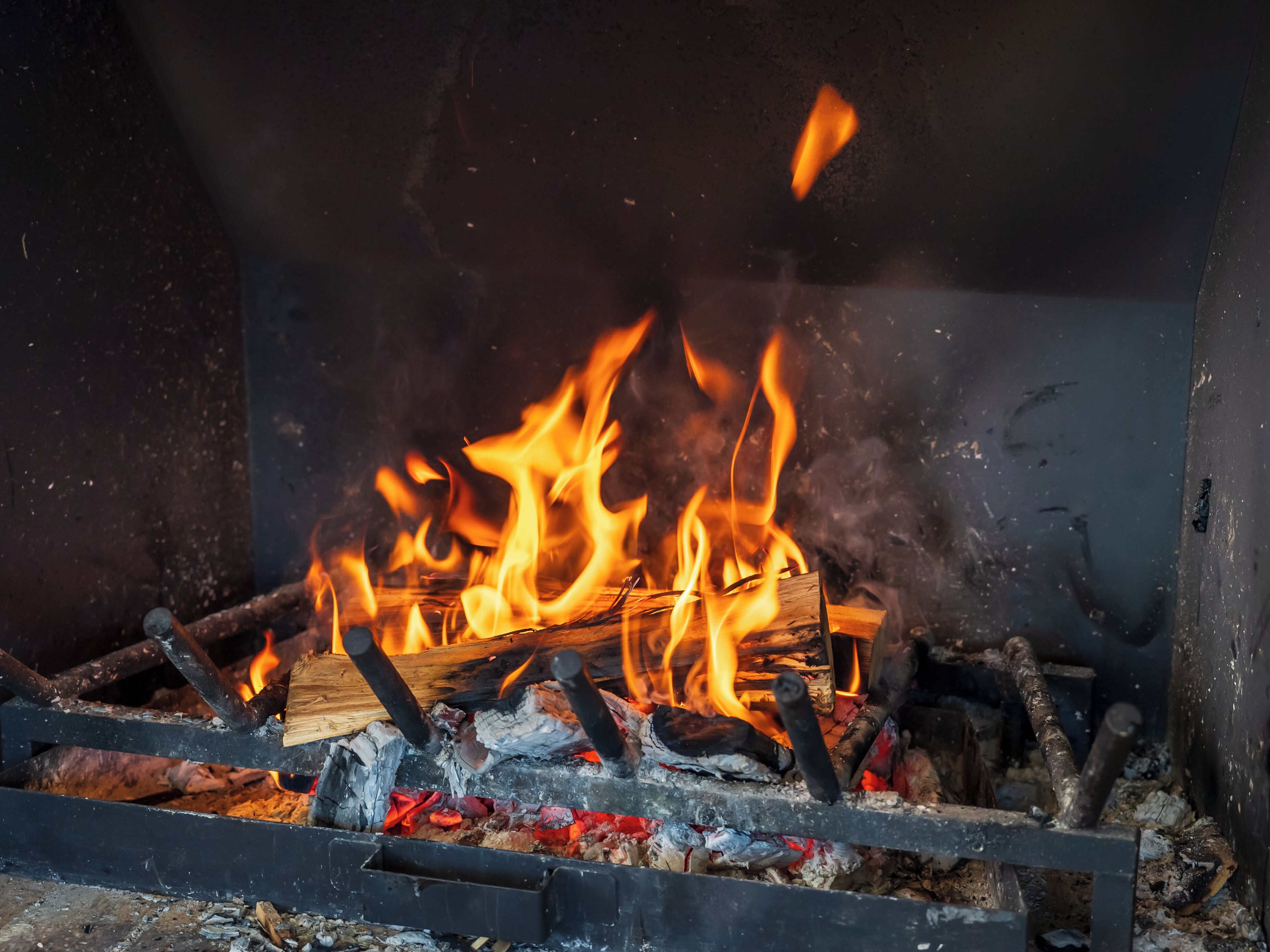 A fireplace with burning logs and flames.