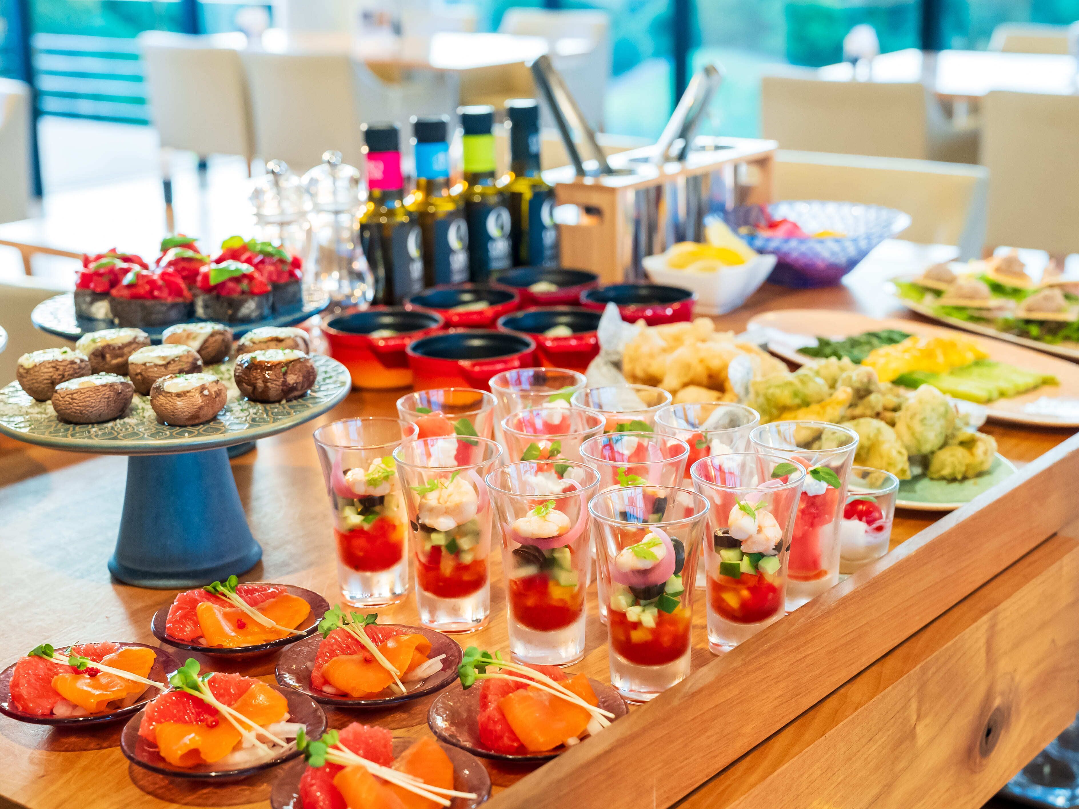 A buffet table with various food items and drinks.