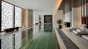 A modern lobby with a reflective floor, seating area, and decorative panels. - Sofitel Riyadh Hotel & Convention Centre (Riyadh)