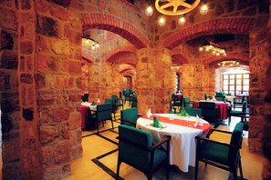 Enjoy meals in this historic dining area with tables set for a memorable experience.