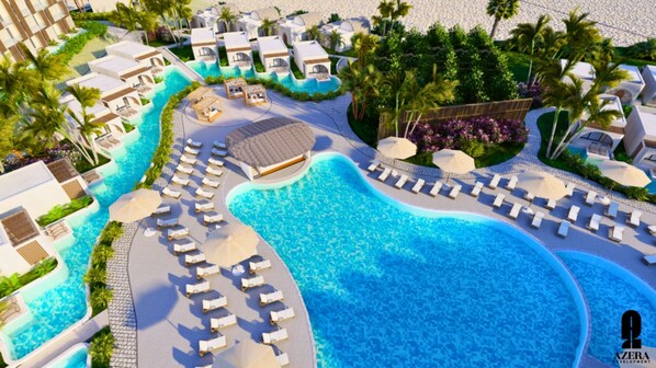 Relax by the resort's curved pool surrounded by sun loungers and umbrellas, amidst lush palm trees and tropical plants.