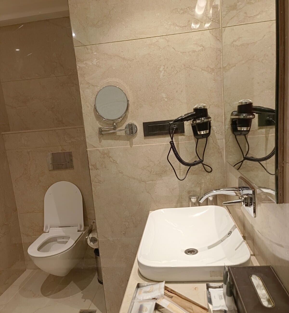 A bathroom with a toilet, bidet, and sink.