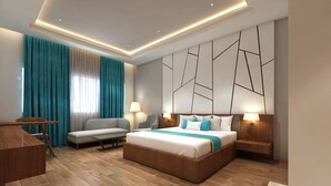 A modern hotel room with a bed, a sofa, a desk, and a chair. - Zone Connect by The Park Prayagraj (Prayagraj)