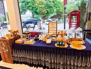 A breakfast buffet with various food items and a sign that reads 'MORNING LOBBY EXPERIENCE.' - Khota Hill Hotel (Nakhon Phanom)