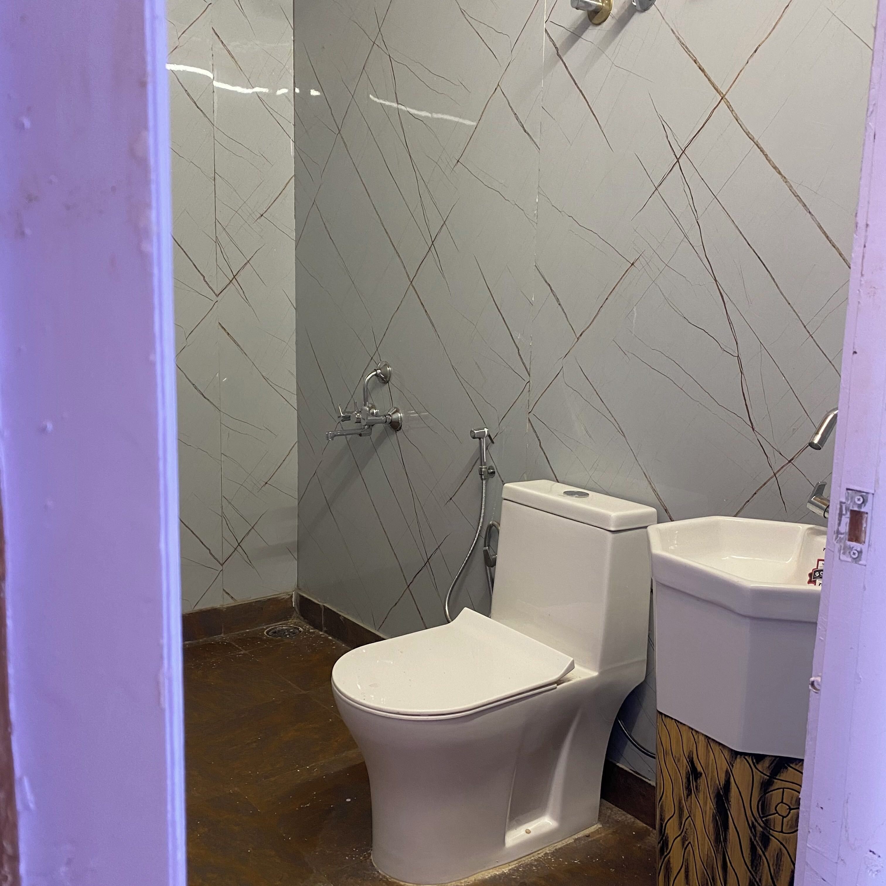 A bathroom with a toilet, bidet, and sink.